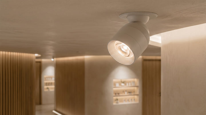 Round anti-glare adjustable LED downlight installed in a hallway, providing soft and focused lighting for modern homes.
