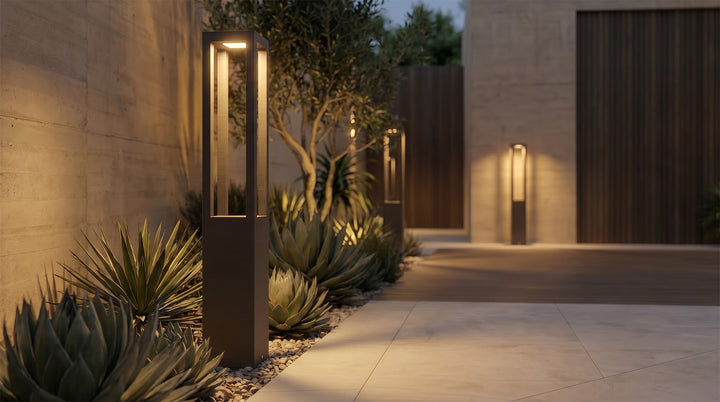 LED bollard garden light with sleek rectangular design, installed along garden pathway for warm and modern illumination