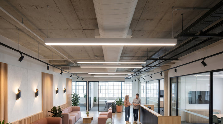 Commercial linear pendant lighting installed in a modern office corridor.