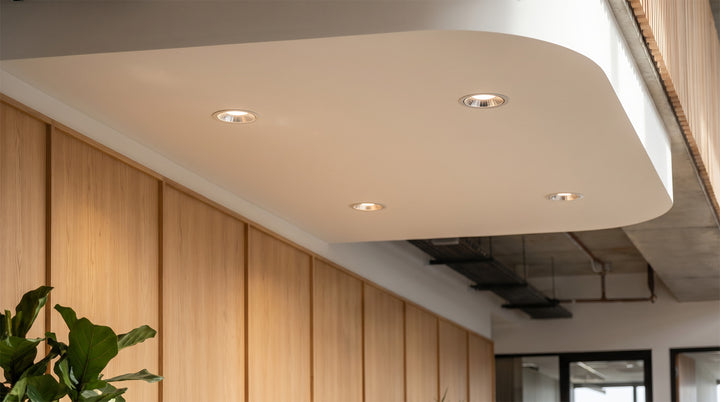 Modern living room with recessed LED spotlights illuminating a minimalist space.
