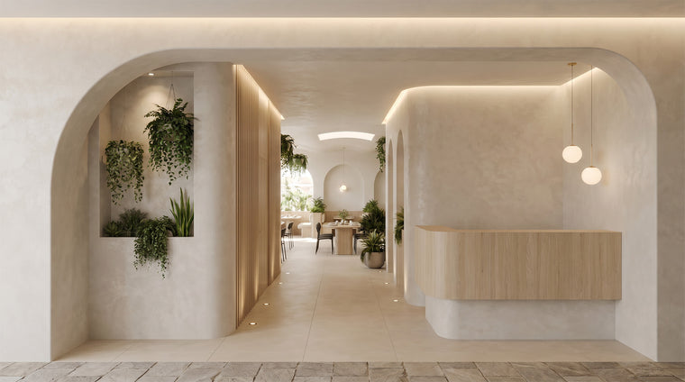 Spacious wabi-sabi cafe dining area with light wood tables, custom booth seating, and hanging ivy plants from the ceiling.
