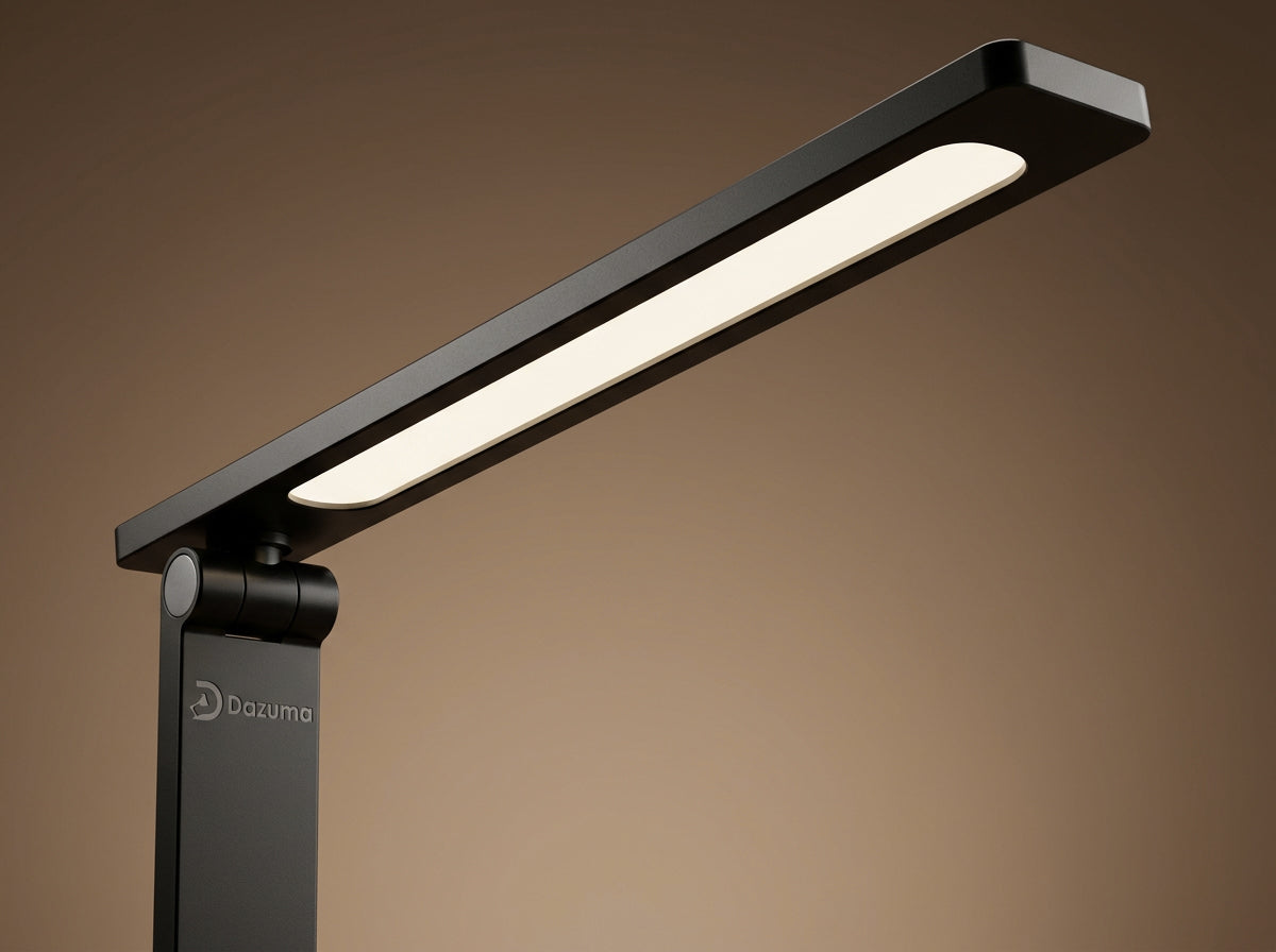 Close-up of a modern black adjustable LED desk lamp by Dazuma emitting warm light.