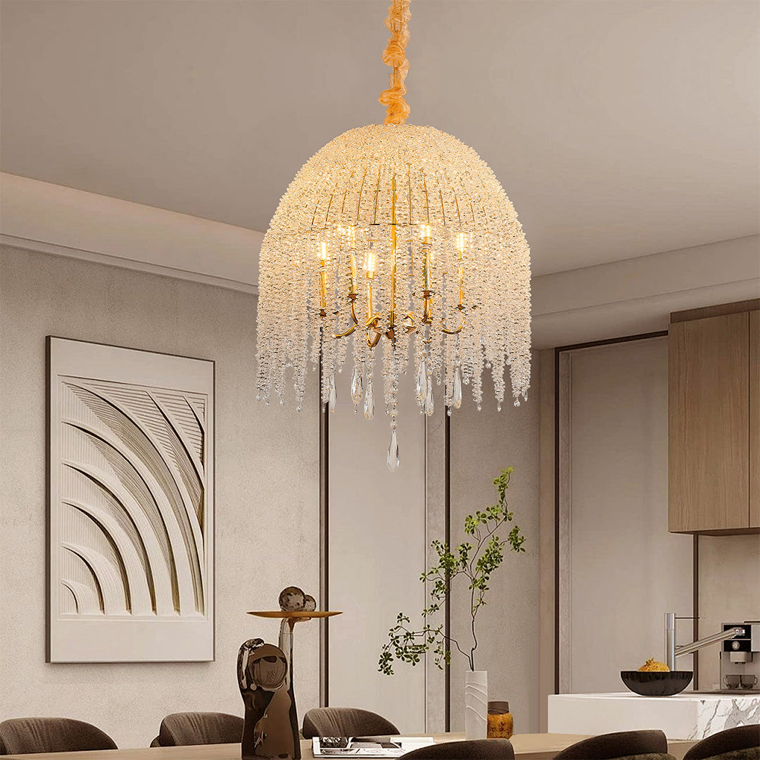 Dining area featuring a gold teardrop crystal chandelier, creating a warm and inviting light effect.
