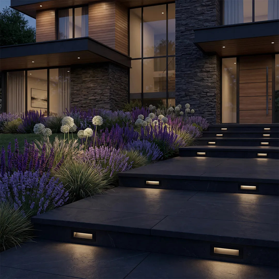 Deck lights for steps embedded along wide modern outdoor stairs, illuminating a landscaped entry path at night.