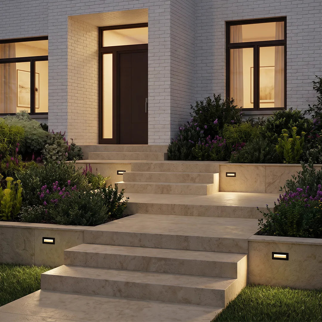 Deck lights for steps installed along outdoor stone stair risers, providing warm and safe pathway illumination.