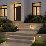 Deck lights for steps installed along outdoor stone stair risers, providing warm and safe pathway illumination.