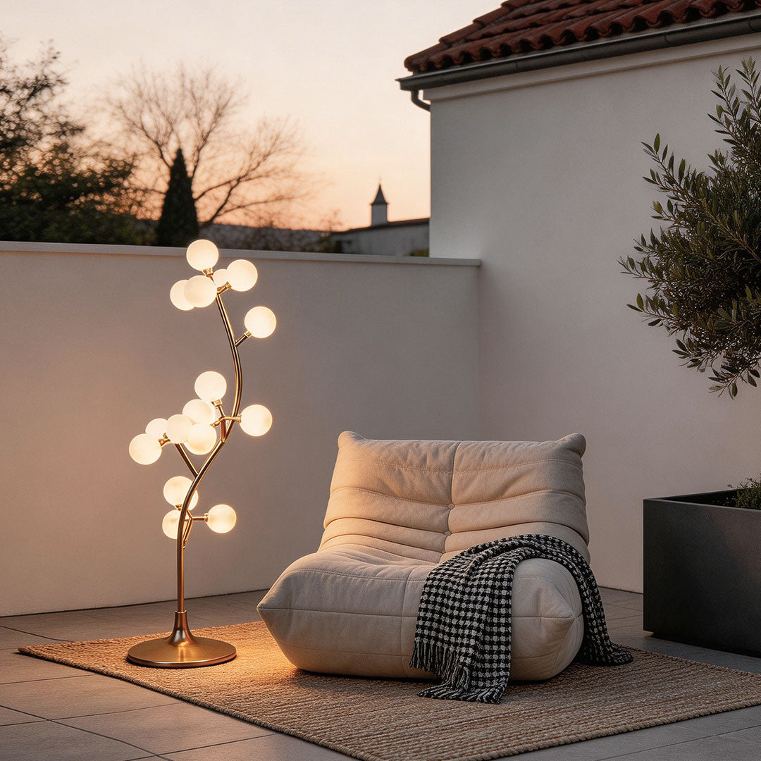 Decorate floor lamp with a contemporary design, illuminating a cozy outdoor seating area.