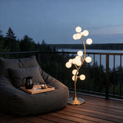 Decorate floor lamp with a modern tree design, featuring spherical lights on a balcony.