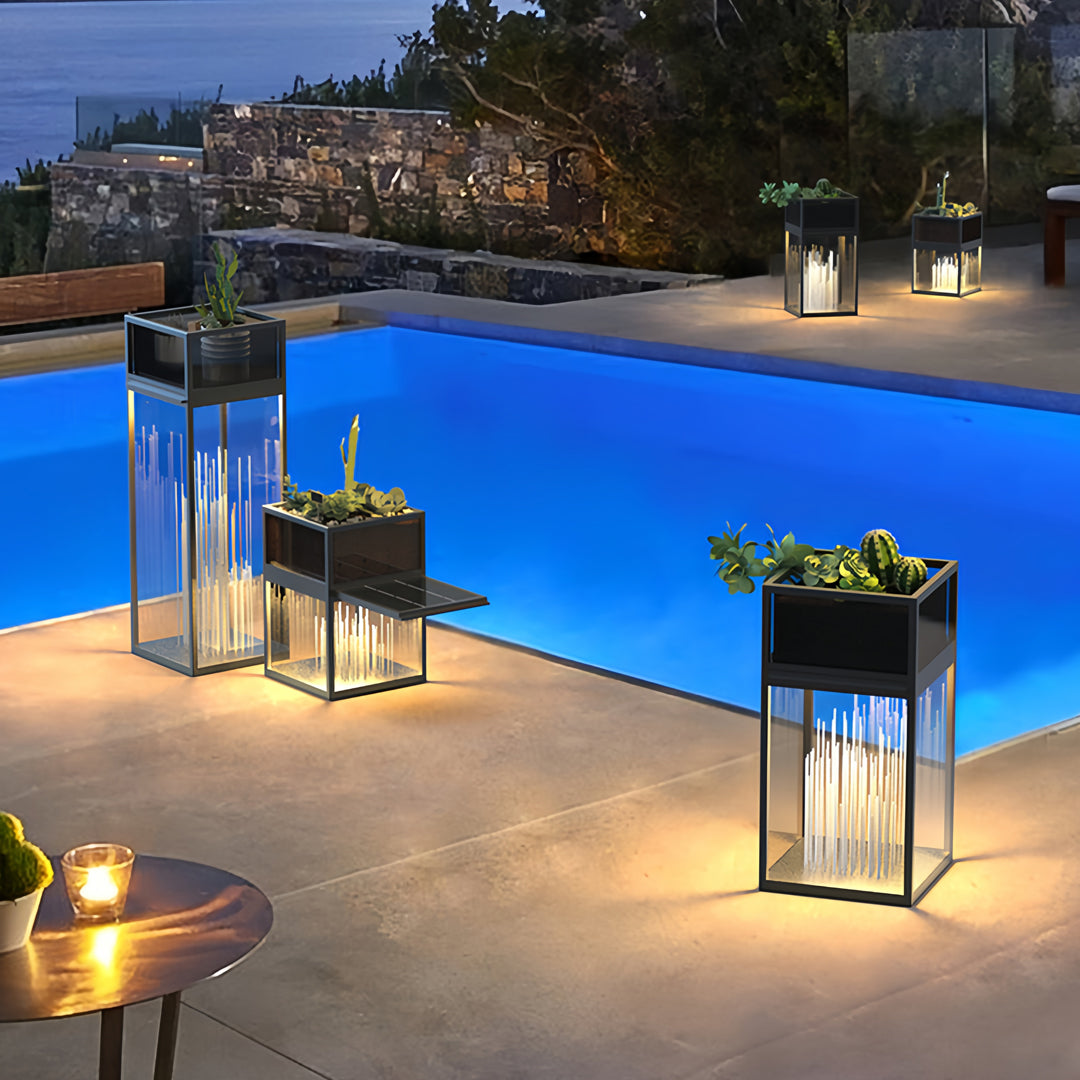 Decorative bollards with lights illuminating a luxury outdoor lounge beside a modern pool area.