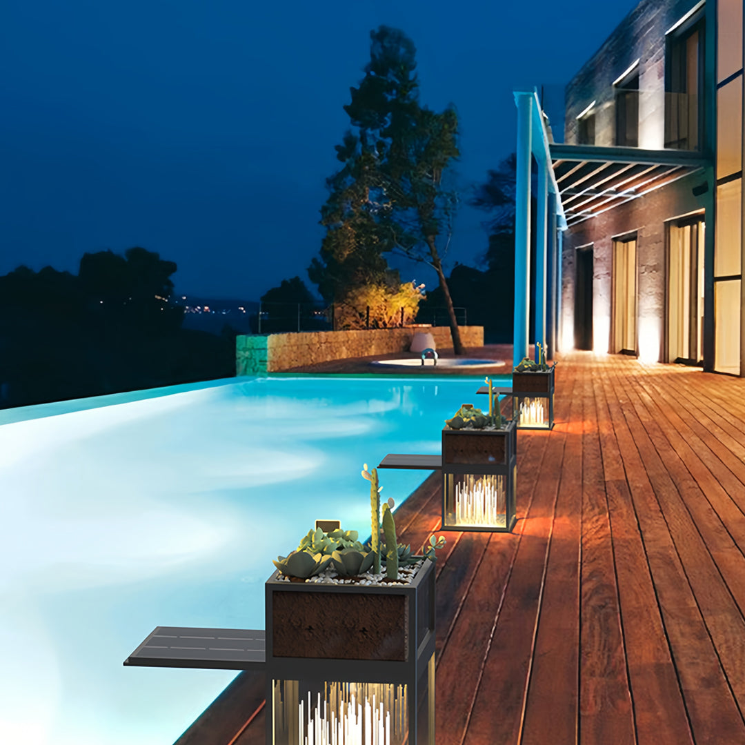 Decorative bollards with lights illuminating a poolside pathway in a modern outdoor setting.