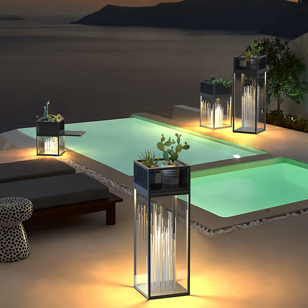 Decorative bollards with lights placed along a waterfront deck, creating a warm inviting ambiance at night.