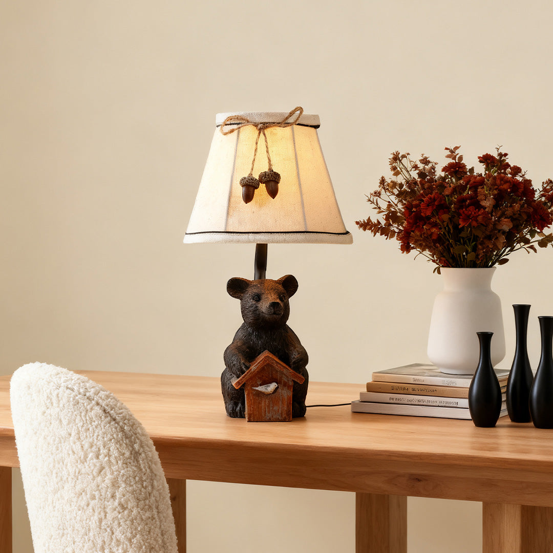Decorative bear table lamp used on a light wooden dining table, adding a cabin or lodge aesthetic to the room decor.
