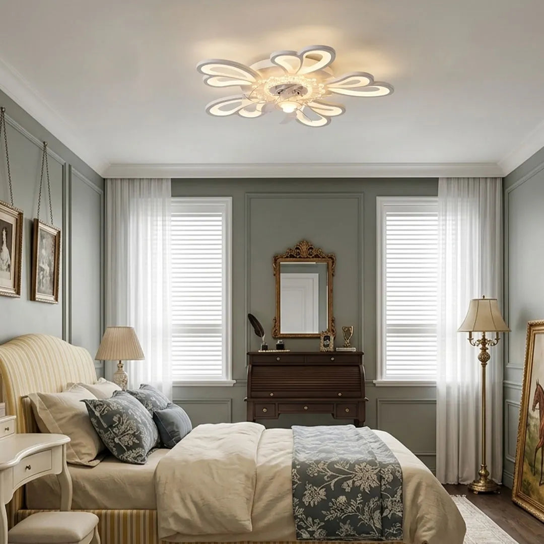 Decorative ceiling fan with lights in a traditional bedroom featuring an ornate floral-inspired design and an integrated LED light.