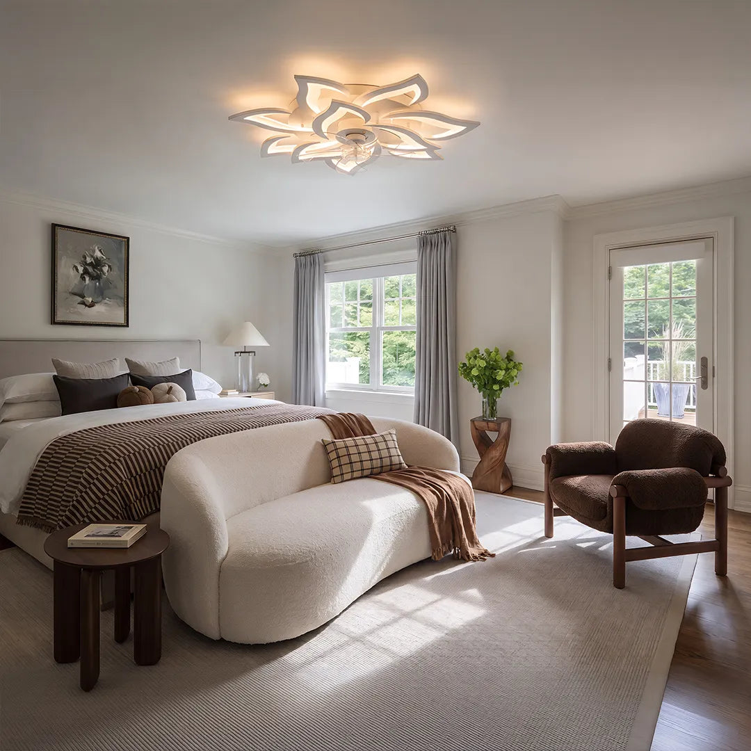 Decorative ceiling fans with lights installed in a cozy bedroom with curved seating and soft daylight.