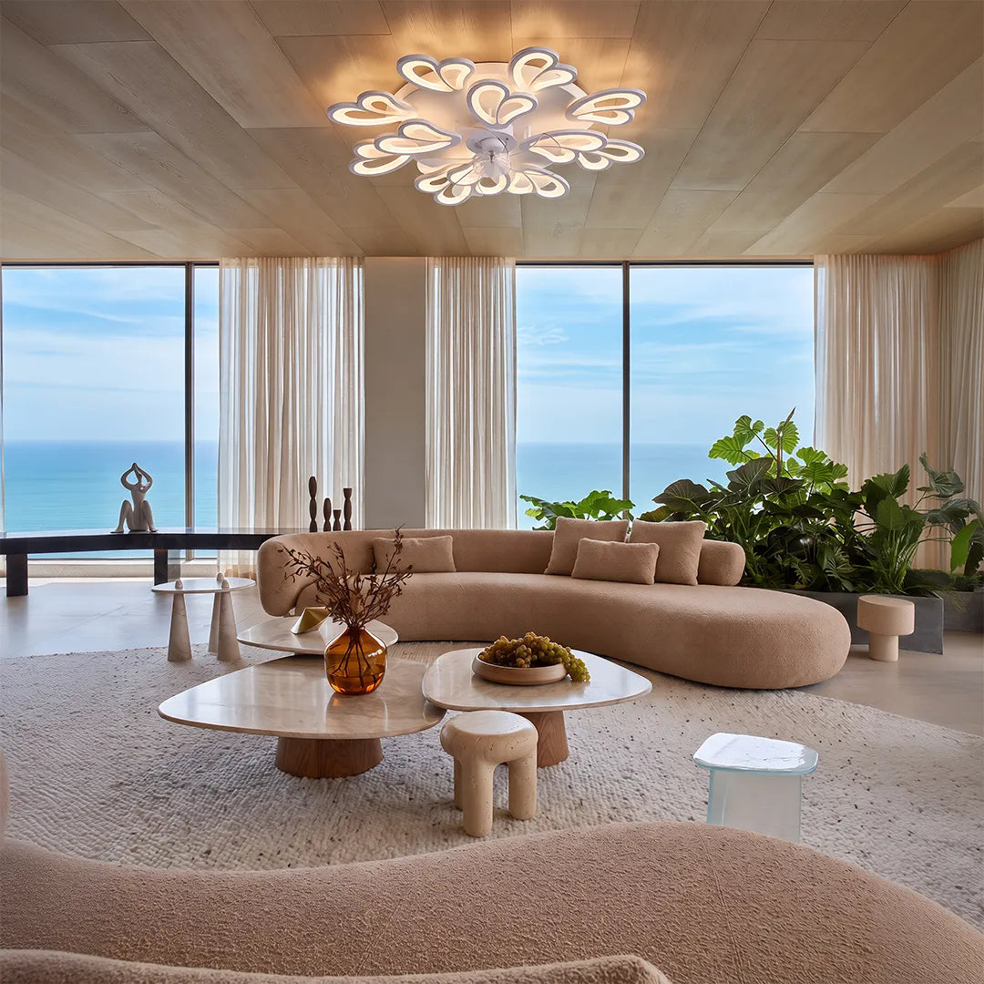 Decorative ceiling fans with lights mounted in a luxury living room with a wood ceiling and sea view.