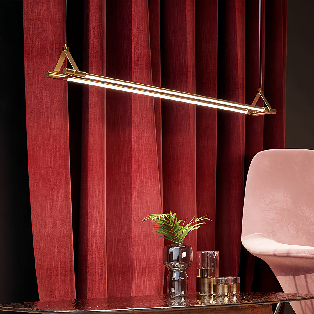 Decorative linear pendant lights with ornate red backdrop creating dramatic interior lighting design