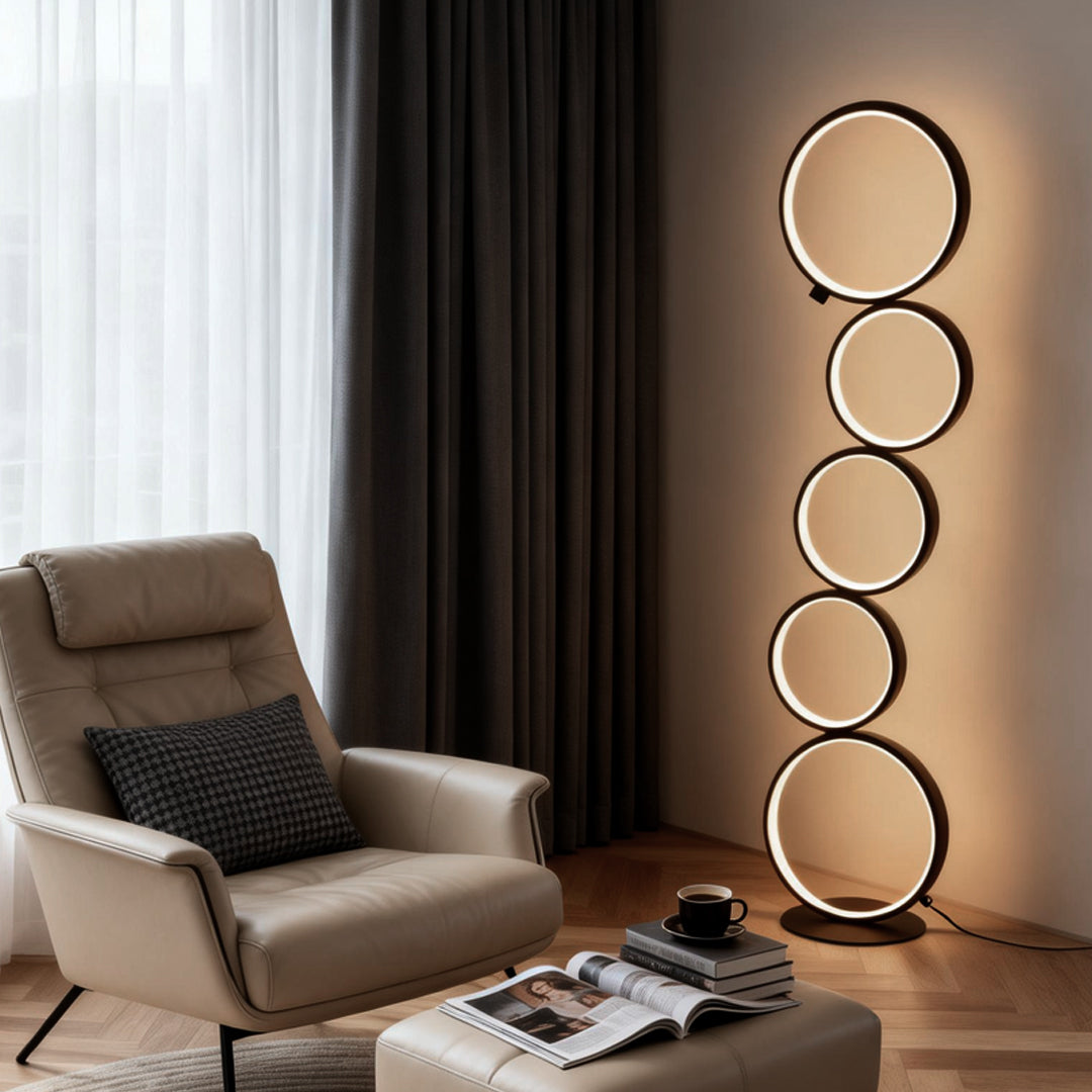Decorative floor lamps with circular LED rings, adding a modern touch to a cozy living room corner.