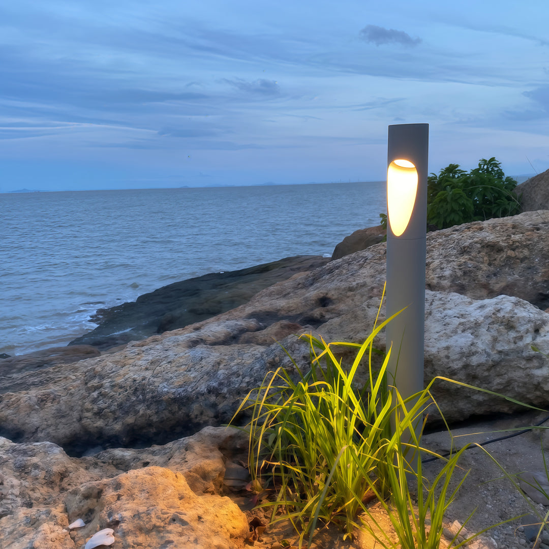 Outdoor seating area styled with decorative garden bollard led lights enhancing the warm evening setting.