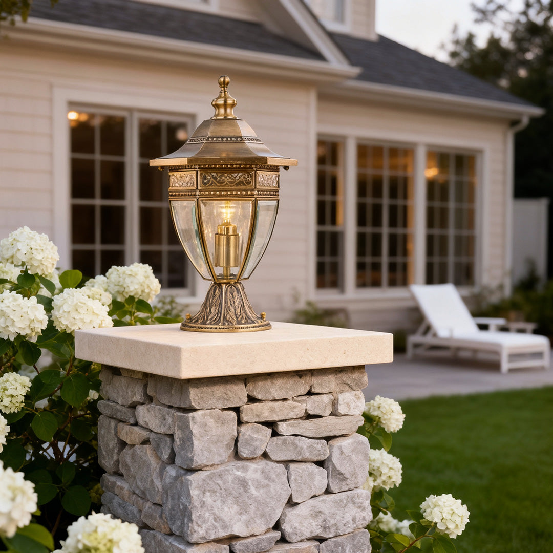 Decorative glass pillar light on a stone wall, providing warm illumination for garden pathways and outdoor ambiance.