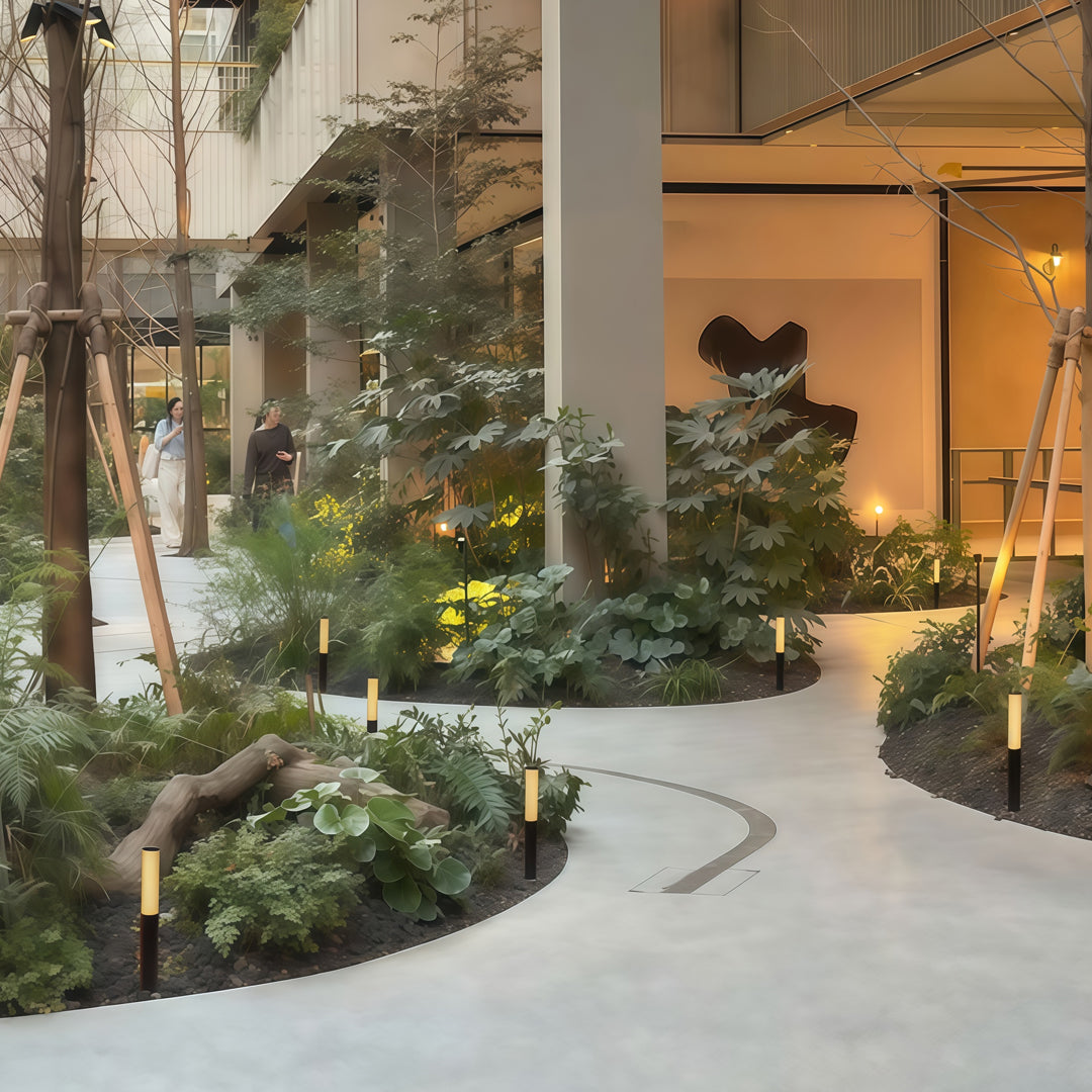 Decorative indoor garden walkway lit by modern led bollard garden light fixtures enhancing natural greenery.