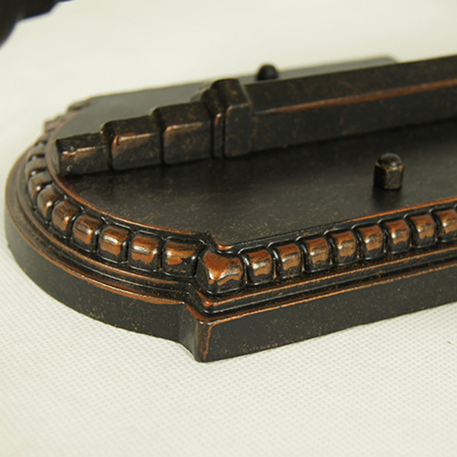 Detailed view of decorative lantern base showing intricate molding and design elements