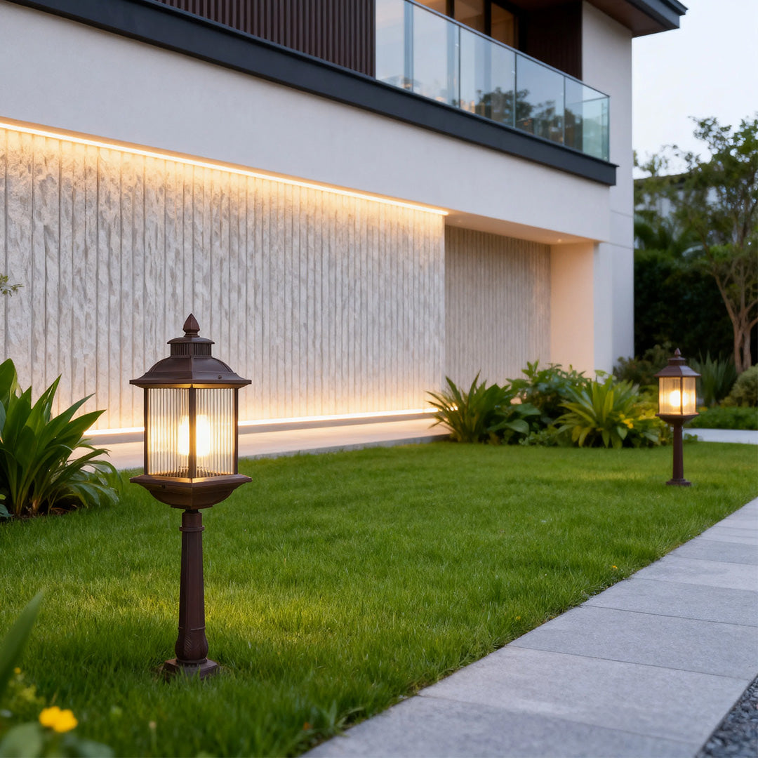 Decorative LED post light with classic lantern top installed along modern home pathway at dusk
