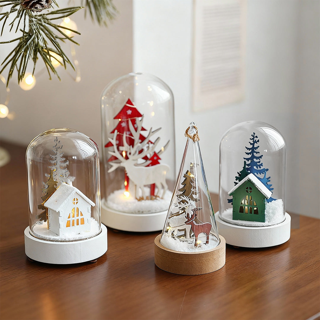 Collection of decorative led table lamp ornaments in various sizes with festive scenes and warm ambient lighting