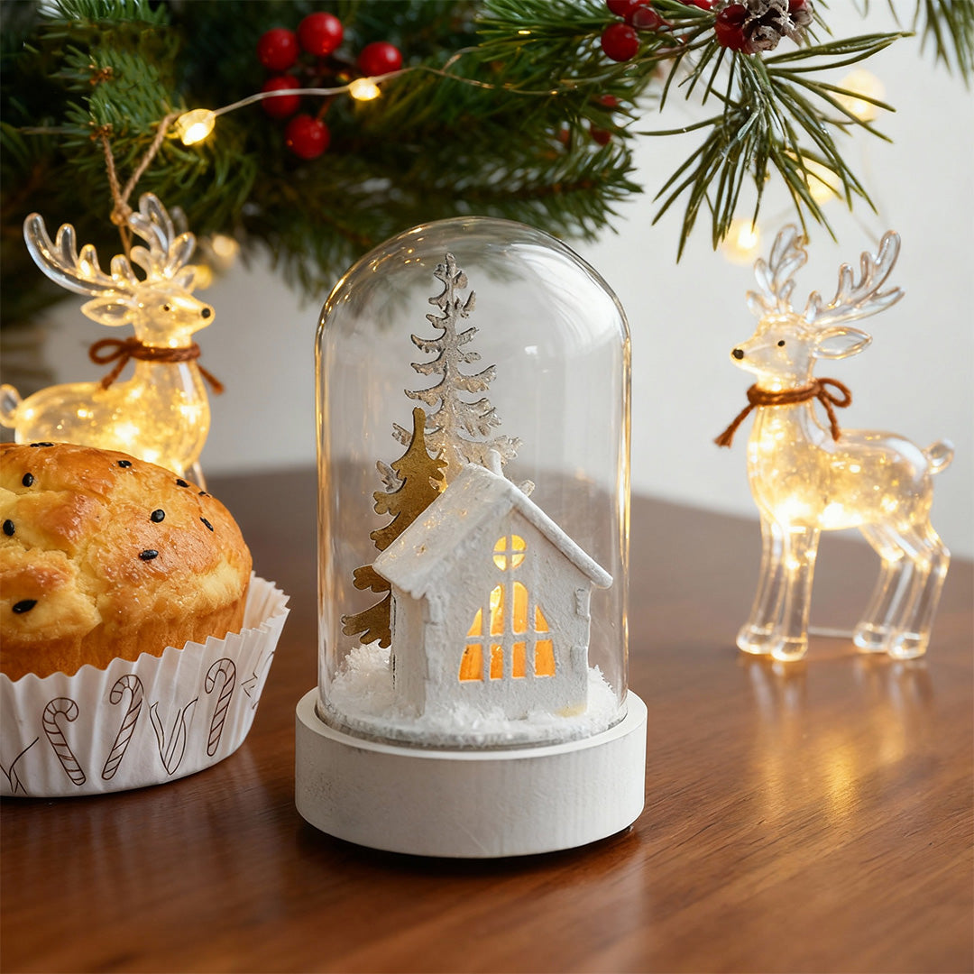 Group of decorative led table lamp displays with glass domes and illuminated festive village scenes on shelf