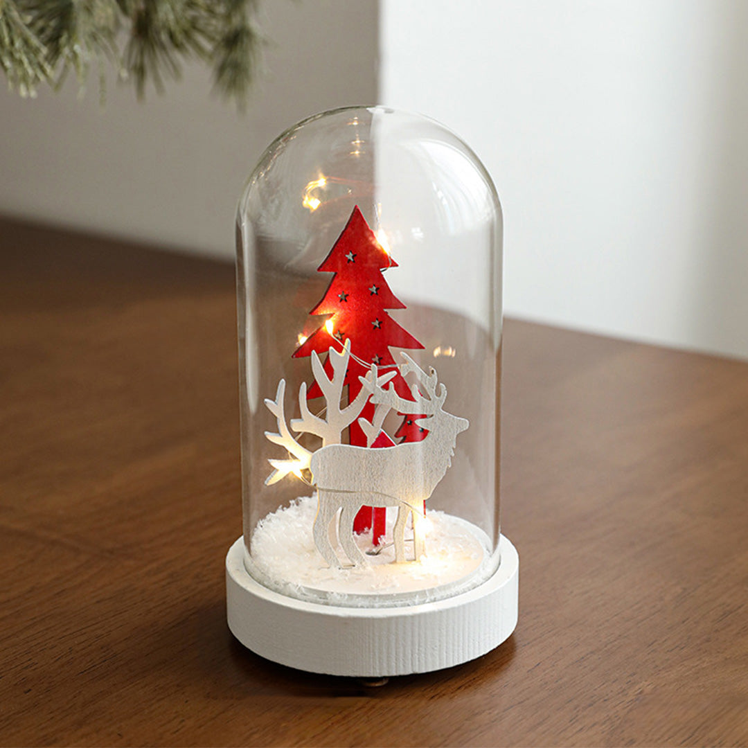 Decorative led table lamp with glass dome containing red Christmas tree miniature with warm lighting on white base