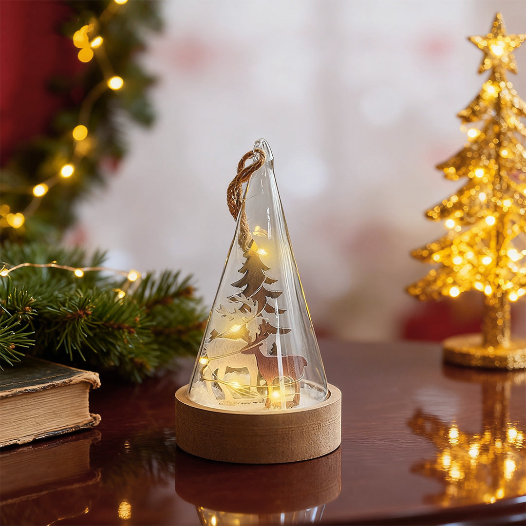 Decorative led table lamp with wood base and glass dome featuring illuminated cone tree among holiday decorations