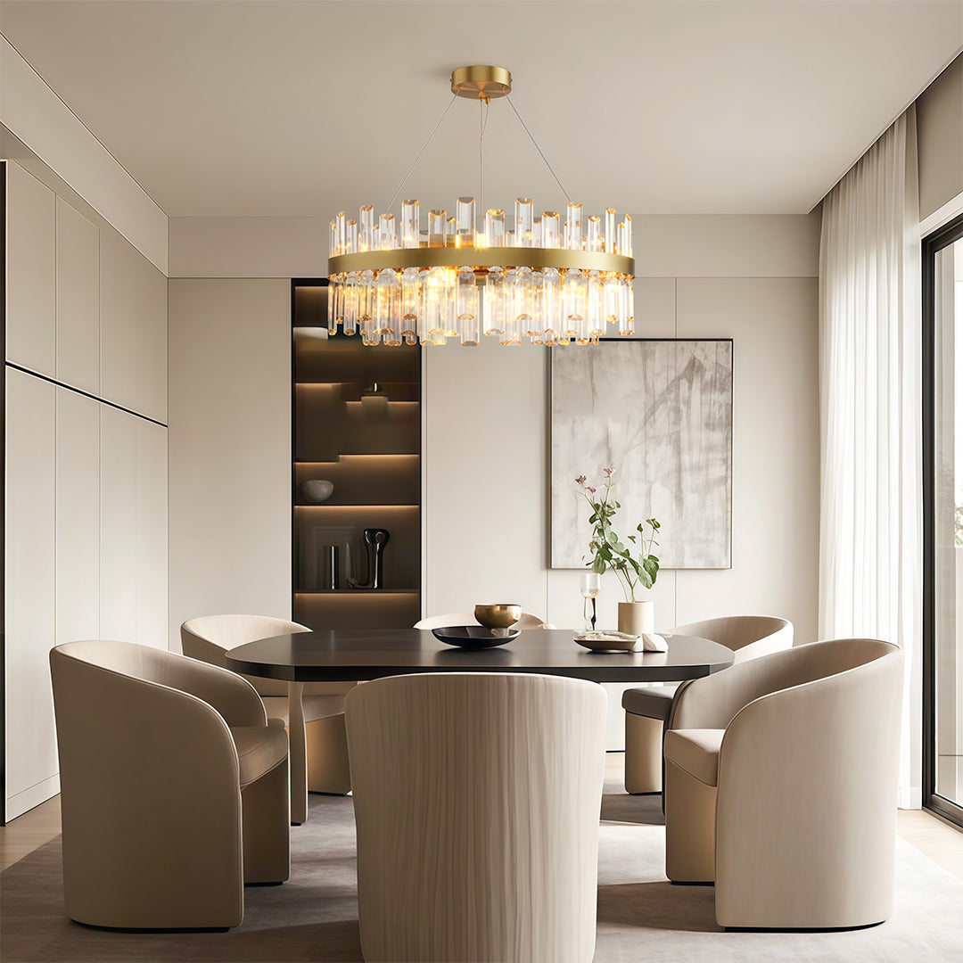 Modern luxury crystal chandelier illuminating elegant dining room with built-in shelving and round table.