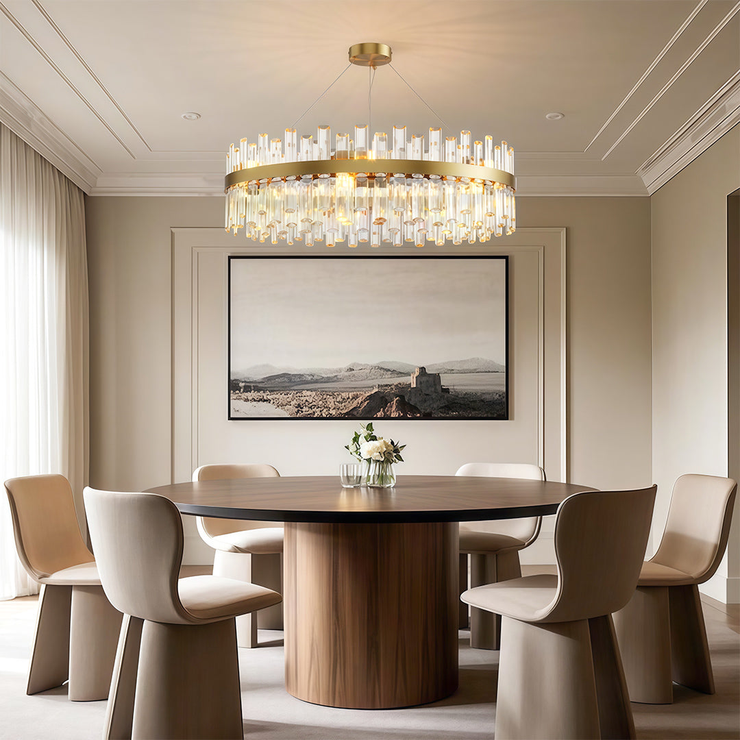 Decorative luxury crystal chandelier lighting sophisticated dining space with wood table and neutral chairs.
