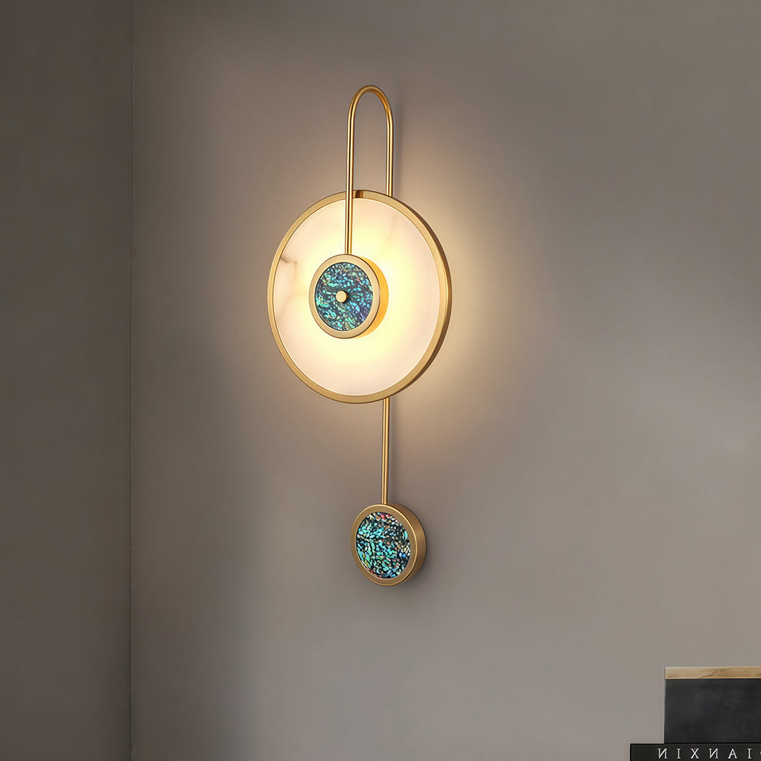 Decorative marble wall light with turquoise accent sphere mounted on minimalist gray interior wall