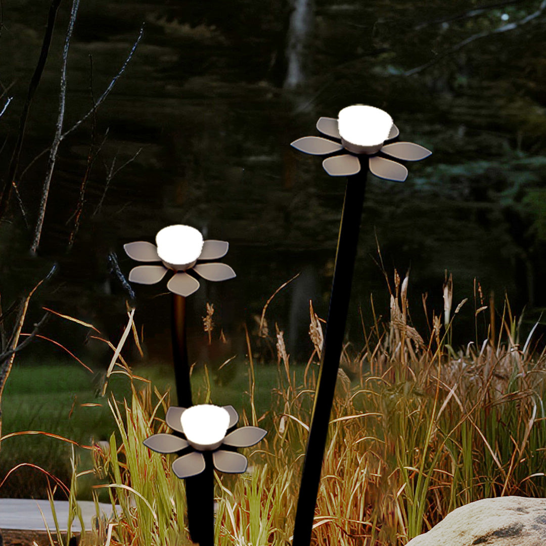 Decorative outdoor landscape lights LED positioned among ornamental grasses creating beautiful textural lighting effects