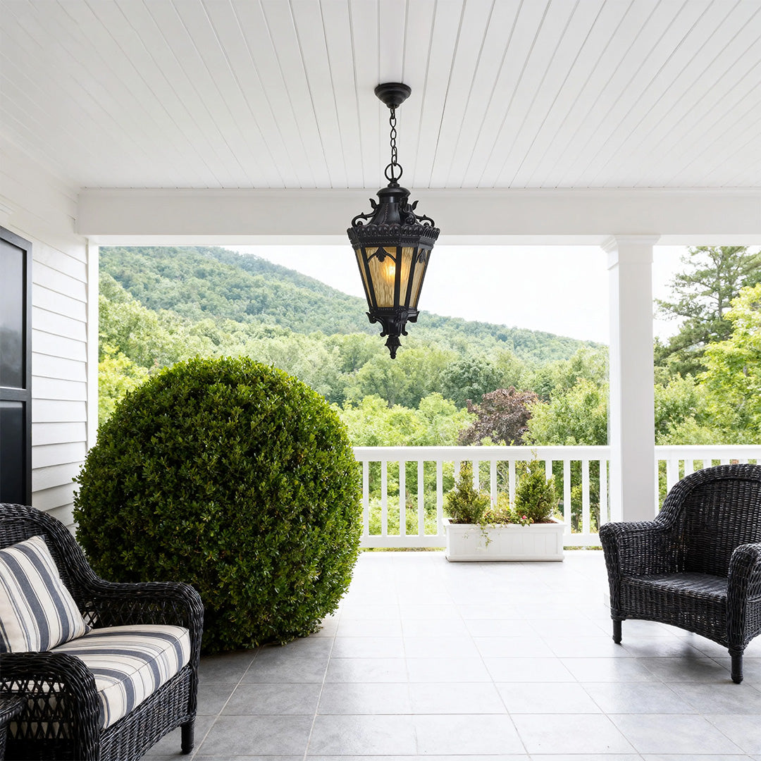 Decorative pendant light outdoor hanging from beadboard ceiling in bright porch with mountain views