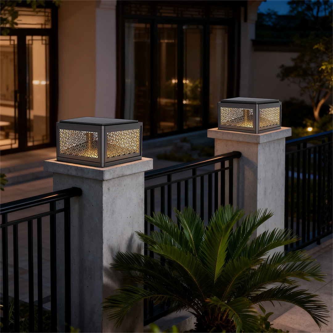 Decorative pillar light installed near a driveway entrance, providing a modern and welcoming glow.