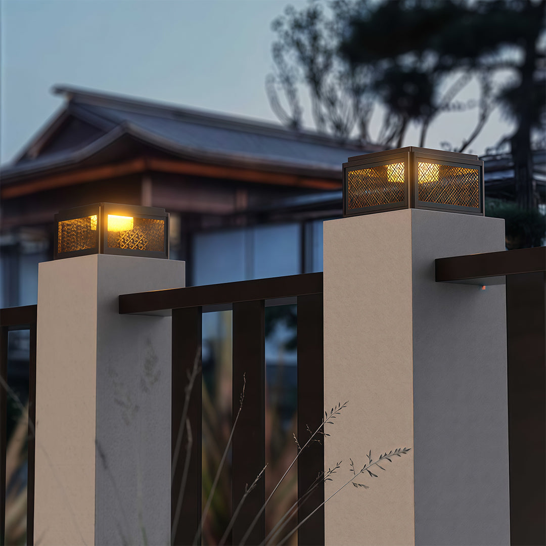 Decorative pillar light placed near a modern fence, enhancing the outdoor ambiance with subtle lighting.