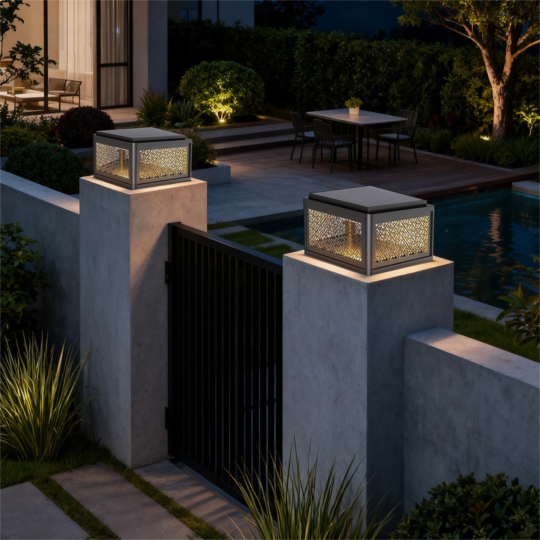 Decorative pillar light along a pathway near a house entrance, offering stylish and functional lighting.