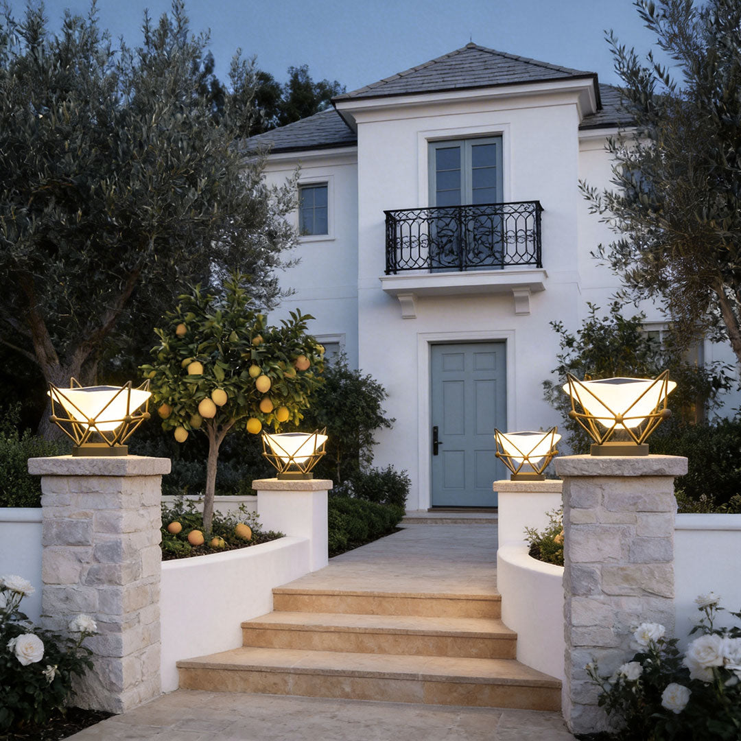 Decorative pillar lights for garden with a unique design, illuminating a pathway near a house.