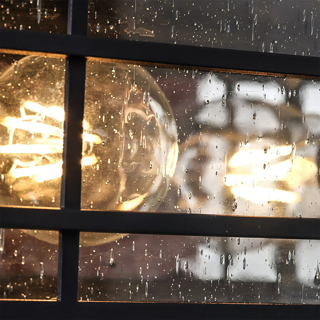 Decorative pillar lights outdoor with textured seeded glass panels and black metal frame details