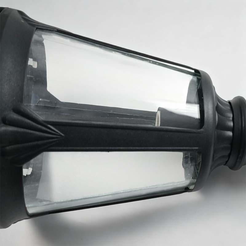 Decorative post light with close-up of the glass and bulb.