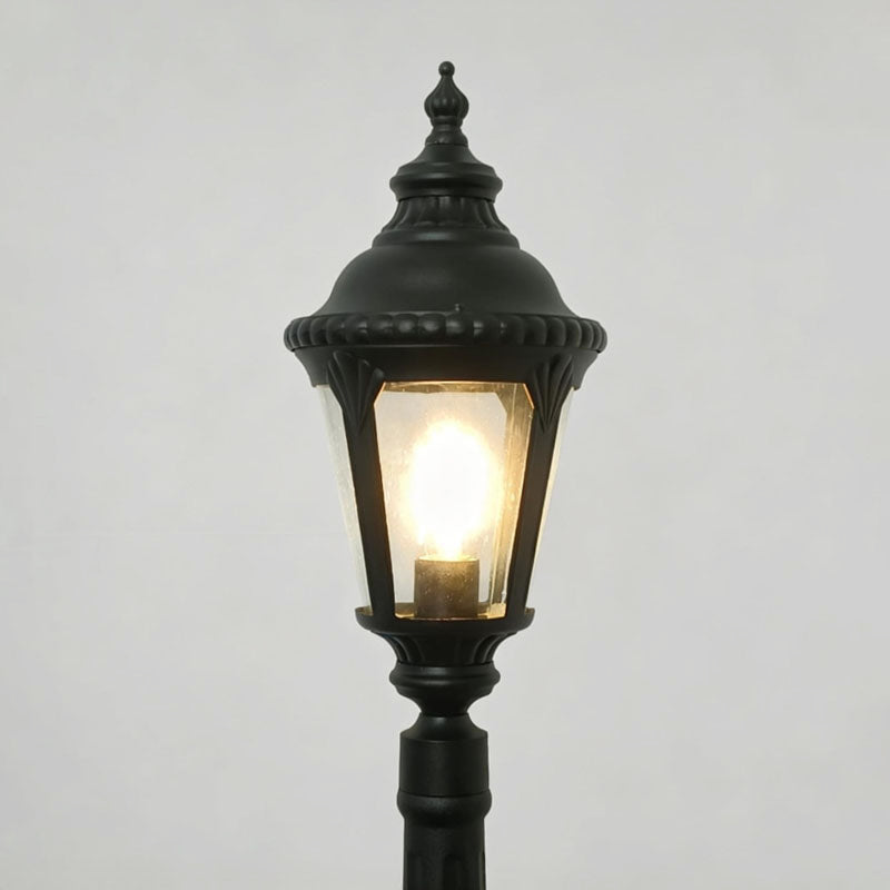 Decorative post light with close-up of its ornate design and light output.