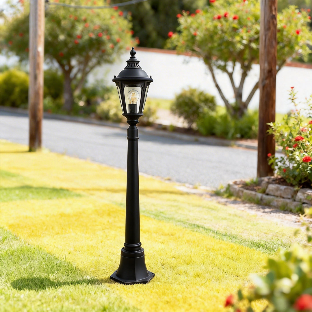 Decorative post light illuminating a minimalist outdoor garden with focused glow.
