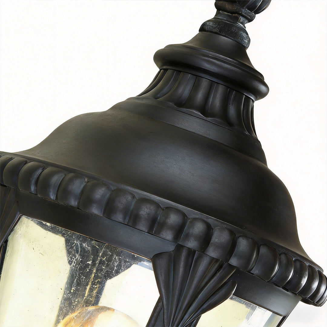 Decorative post light with detailed view of its top and structure.
