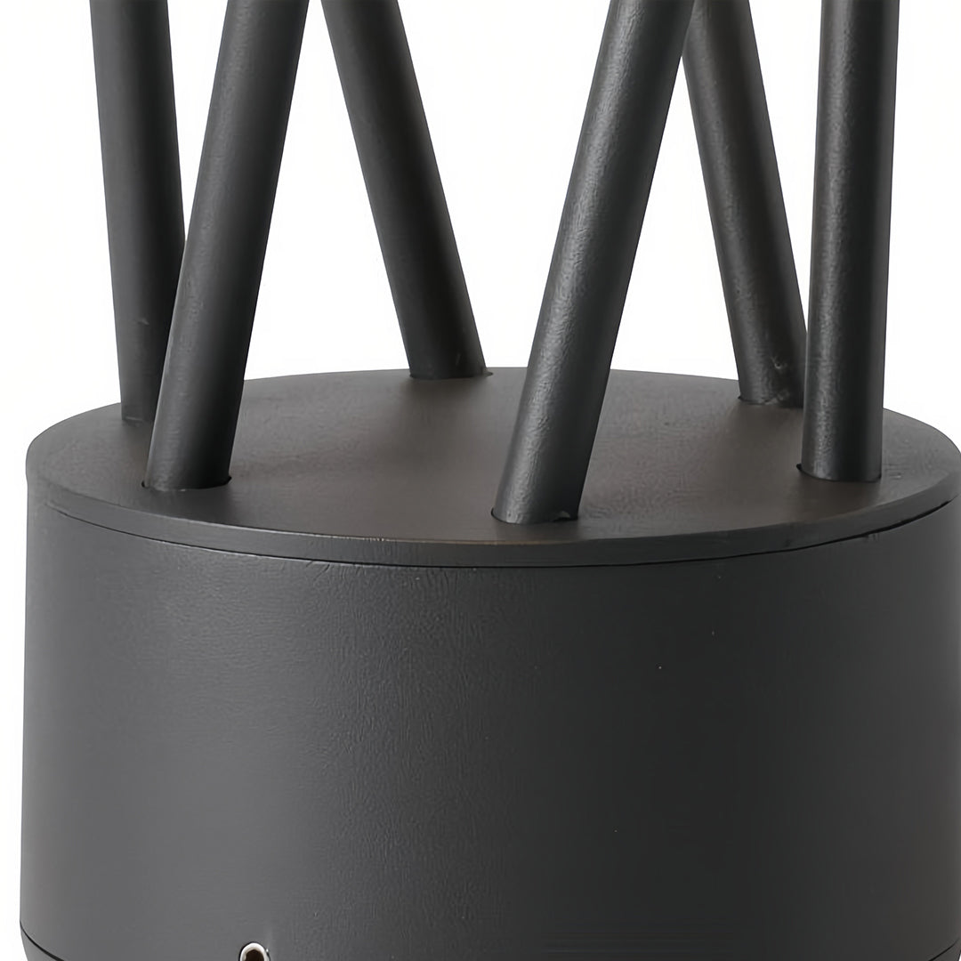 Decorative bright path lights set among rich garden foliage, casting a warm glow on a narrow stone and dirt path.