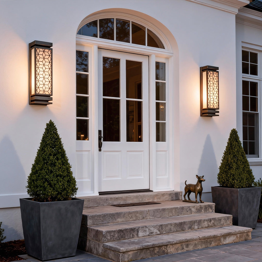 Decorative square wall sconce light on a stone facade, creating a welcoming ambiance for outdoor spaces.