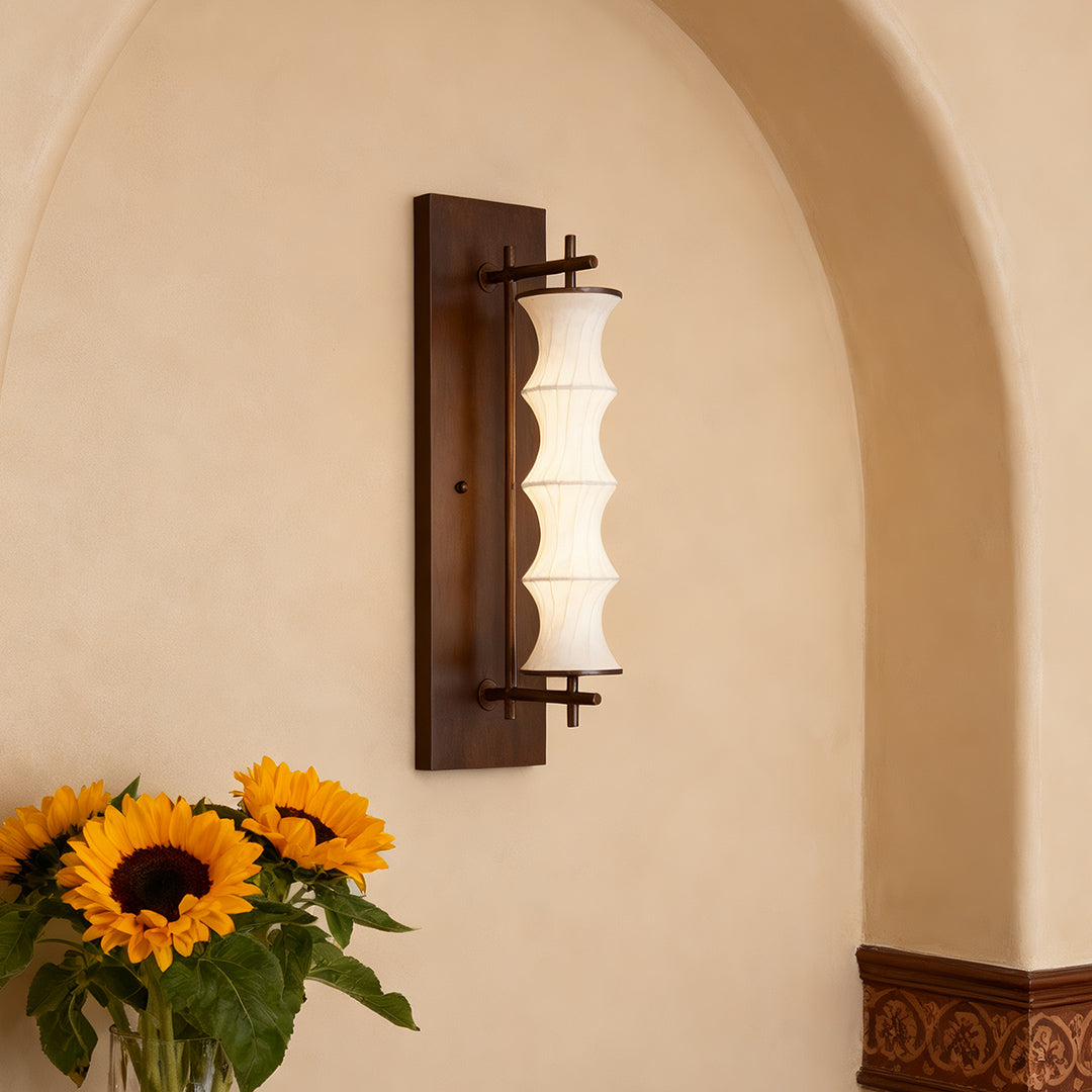 Decorative vintage light wall art piece, emphasizing the texture of the fabric shade and the rich color of the vertical wooden mounting.