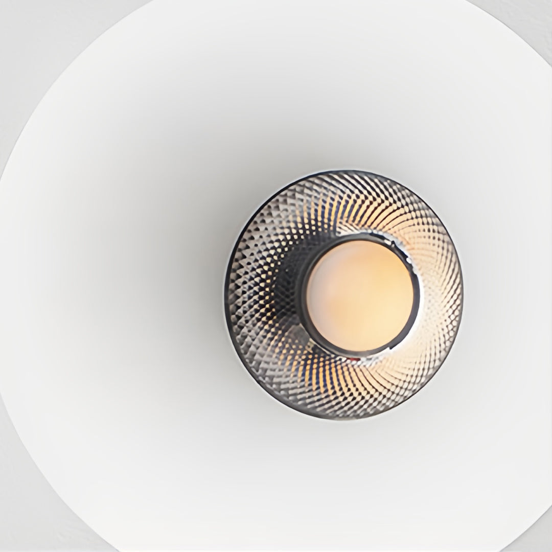 Decorative trimless recessed downlight with textured gold trim and round white housing from top view