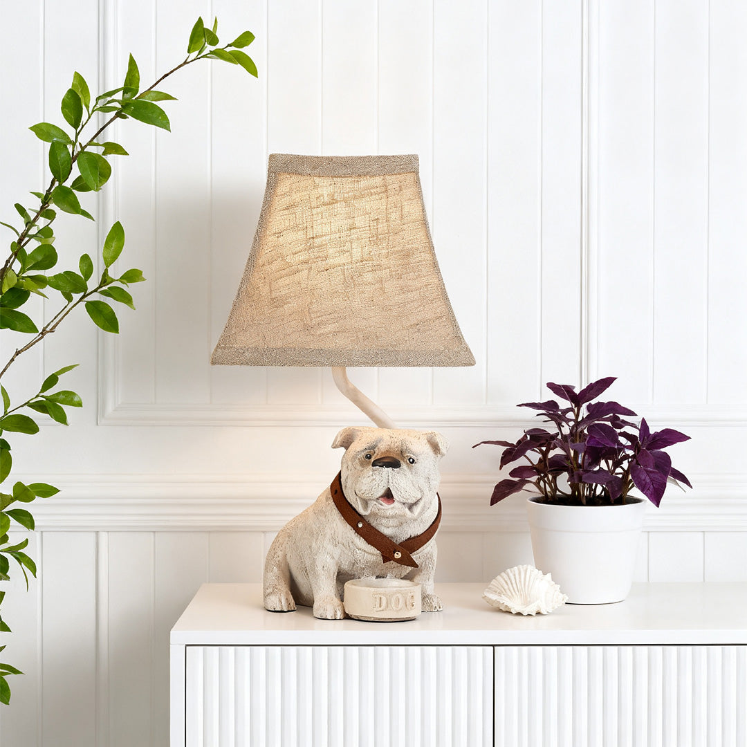 Decorative dog table lamps (Bulldog) resting on a white accent cabinet, adding a whimsical touch to the living room decor.