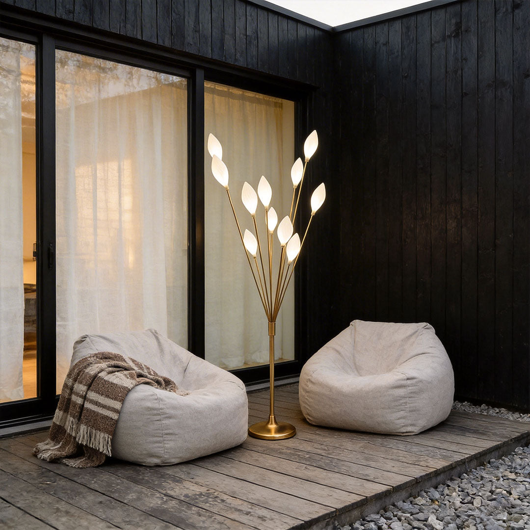 Decorator floor lamps with a modern leaf design, providing warm illumination near a patio.